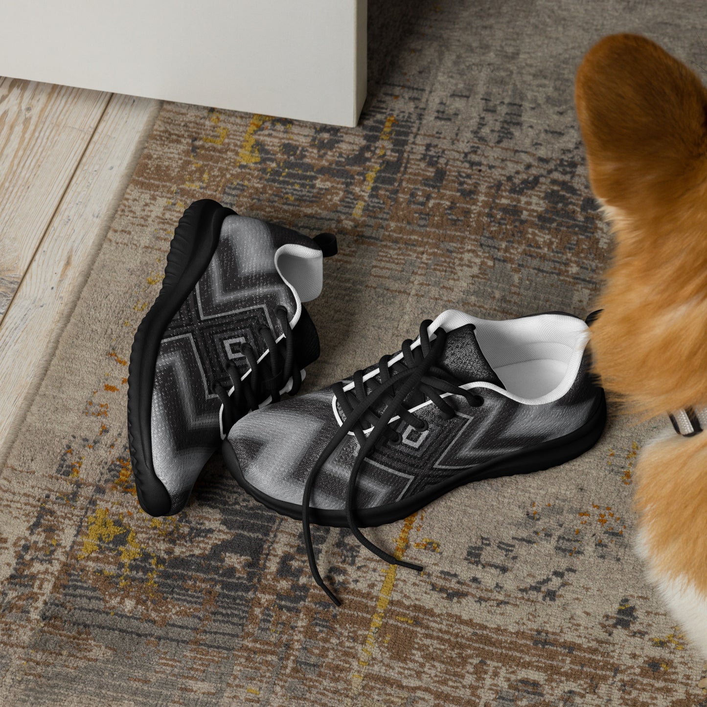 pair of men’s athletic shoes with black sole and layered black gray white geometric design