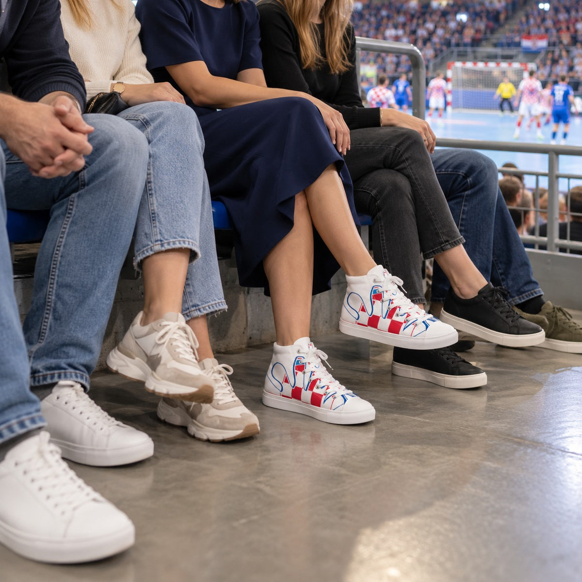 Woman in cuffed jeans and a red T-shirt wearing white Croatian fan high-top sneakers with red checks and blue graphics at a cafe.