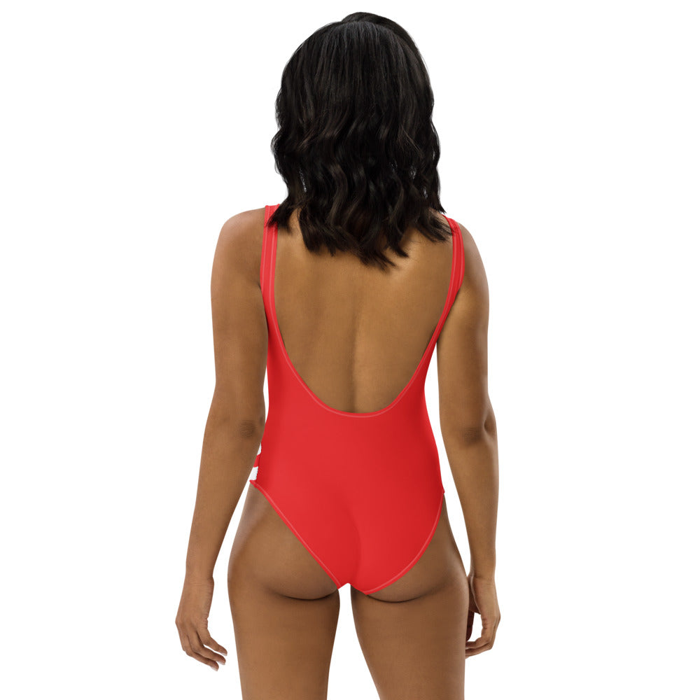 Back view of woman wearing a red American Pride one-piece swimsuit with low scoop back