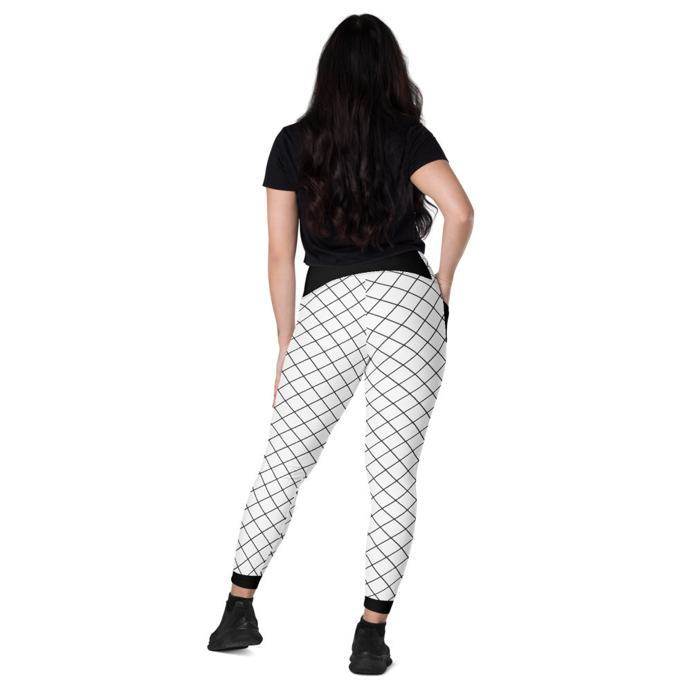 Angled back view of woman wearing black and white grid leggings with pockets and black ankle accents