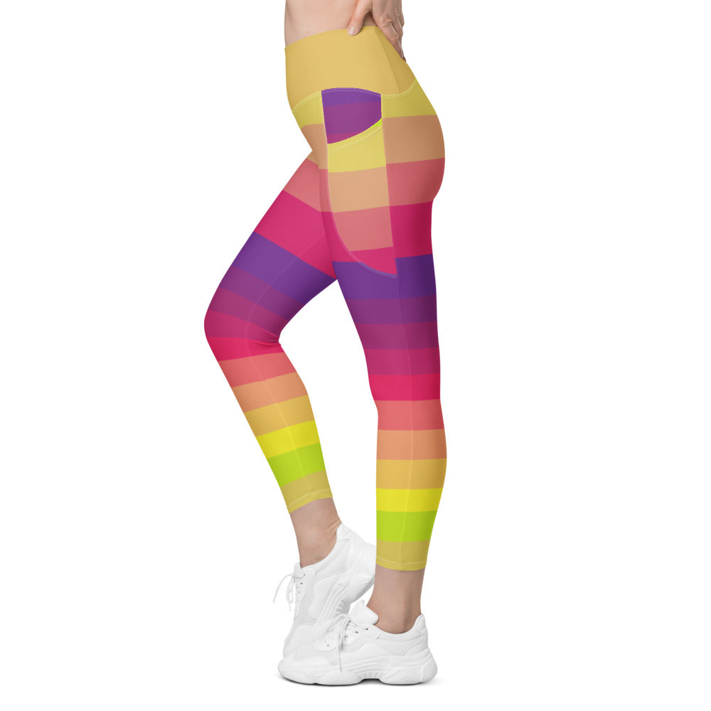 Side view of woman wearing colorful striped leggings with pockets in yellow coral pink purple and lime