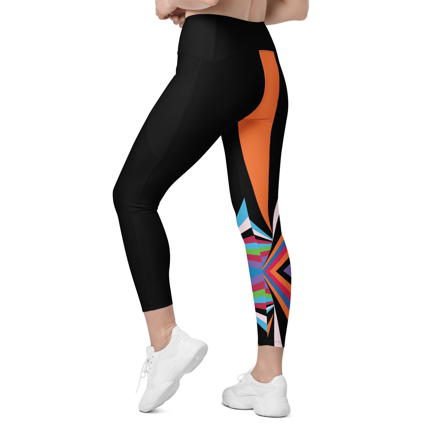 Back angled view of black geometric leggings with colorful abstract pattern concentrated around the lower leg