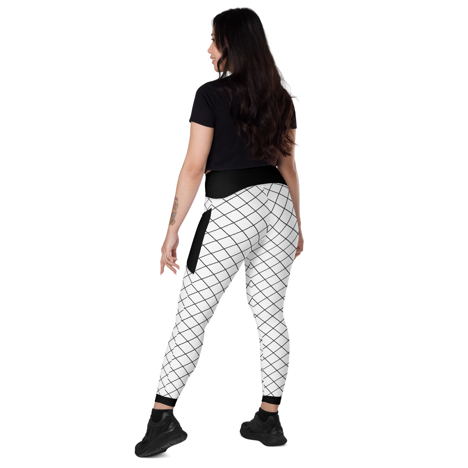 Back view of women's black and white grid leggings with side pockets and high-rise black waistband