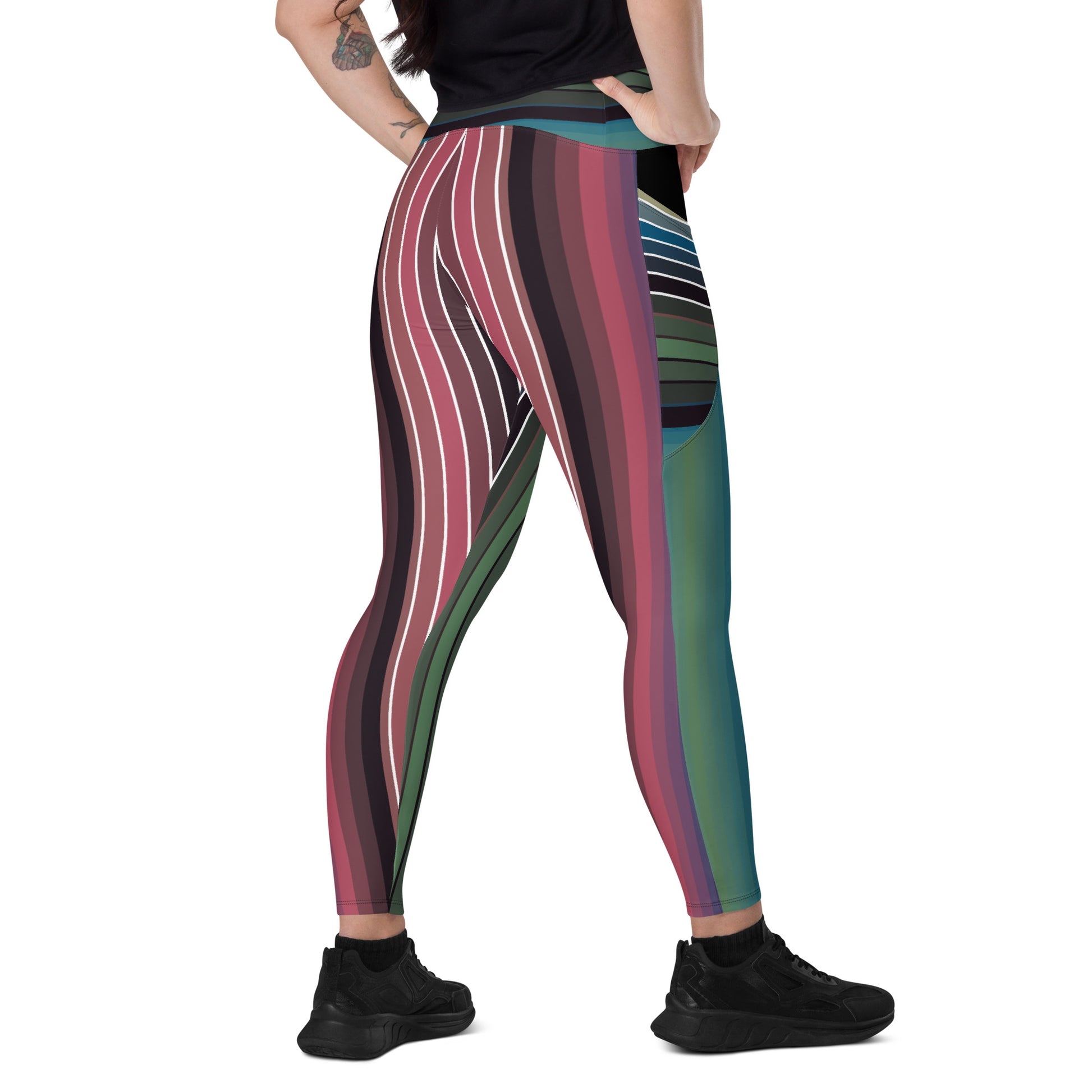 Back angled view of women's striped leggings with curved multicolor bands and side pockets