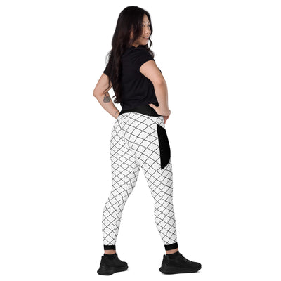 Front view of woman wearing black and white geometric grid leggings with pockets and black waistband