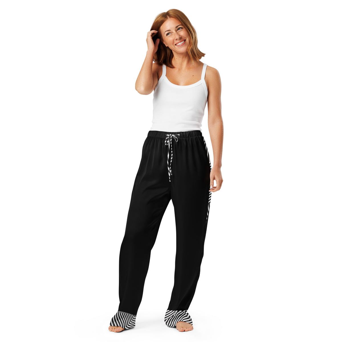 Woman wearing black women's pajama pants with black and white striped cuffs and drawstringmockup