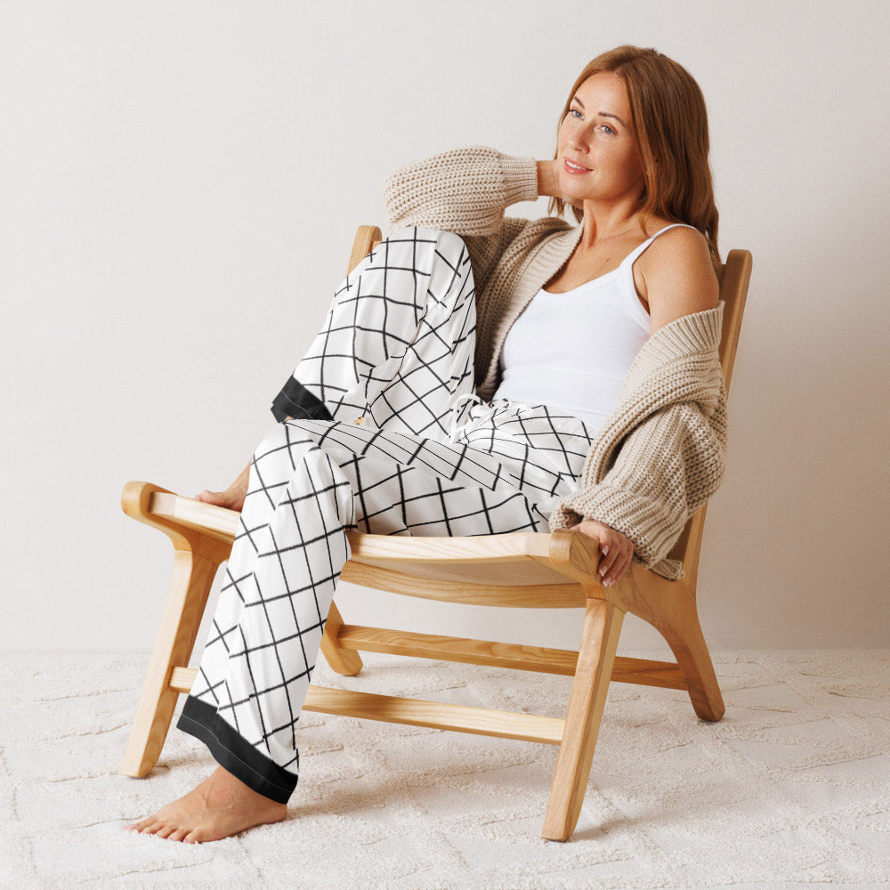 Woman relaxing in black and white geometric grid pajama pants