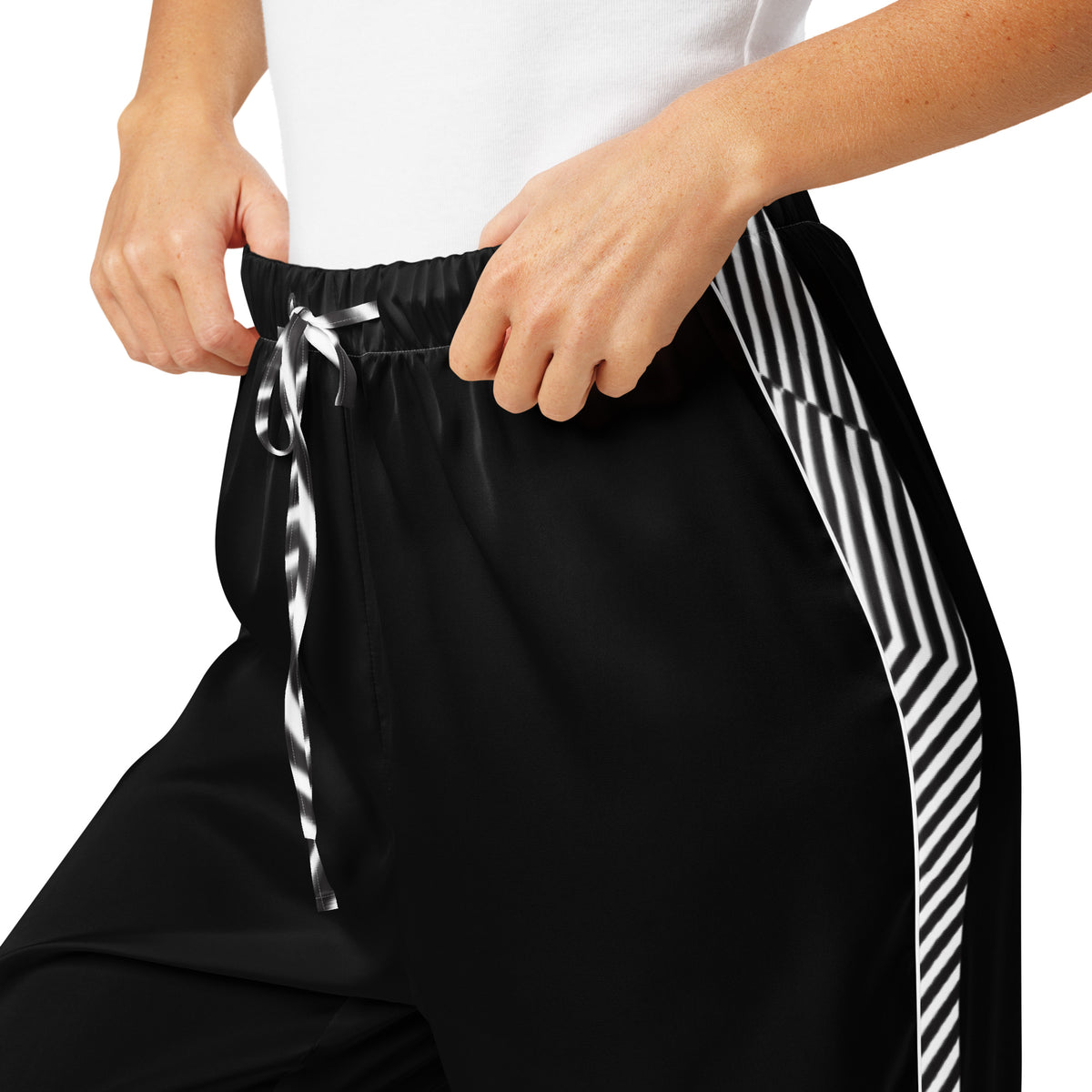 Close-up of black women's pajama pants with striped drawstring and side detail
