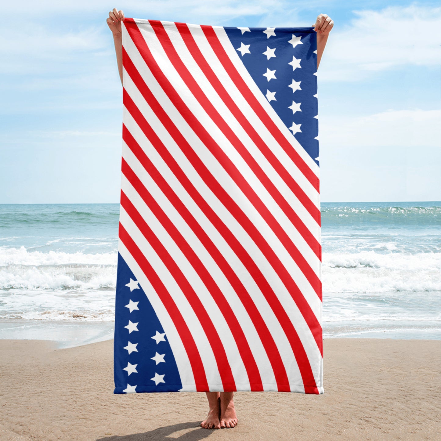 American stars and stripes beach towel held vertically on the beach with diagonal red white stripes and blue star panels