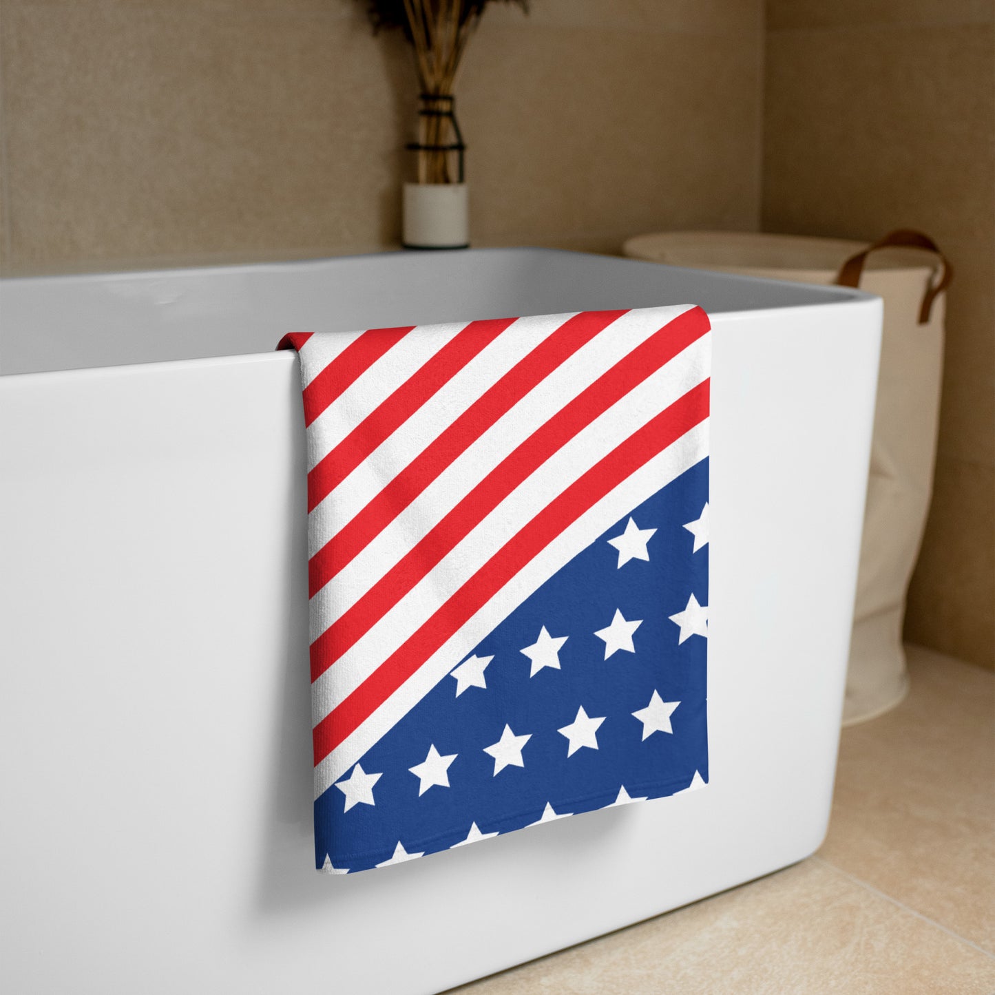 American stars and stripes beach towel draped over a bathtub with red white stripes and blue star field