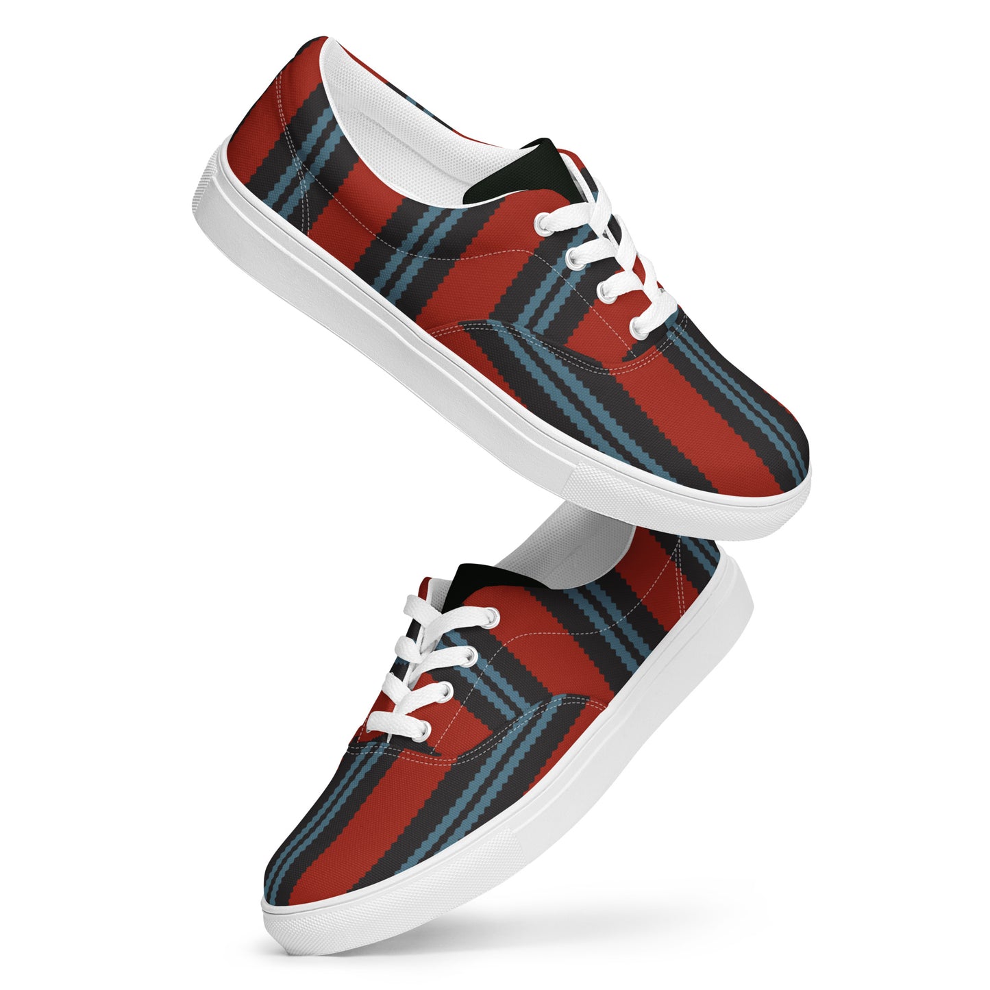 side view of men’s lace-up canvas shoes with dark graphic stripes across a warm red upper