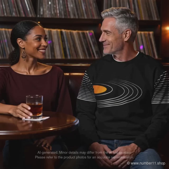 AI-generated video of a man wearing a black vinyl-record sweatshirt beside a woman in a retro music bar, ending with a close-up of the print.