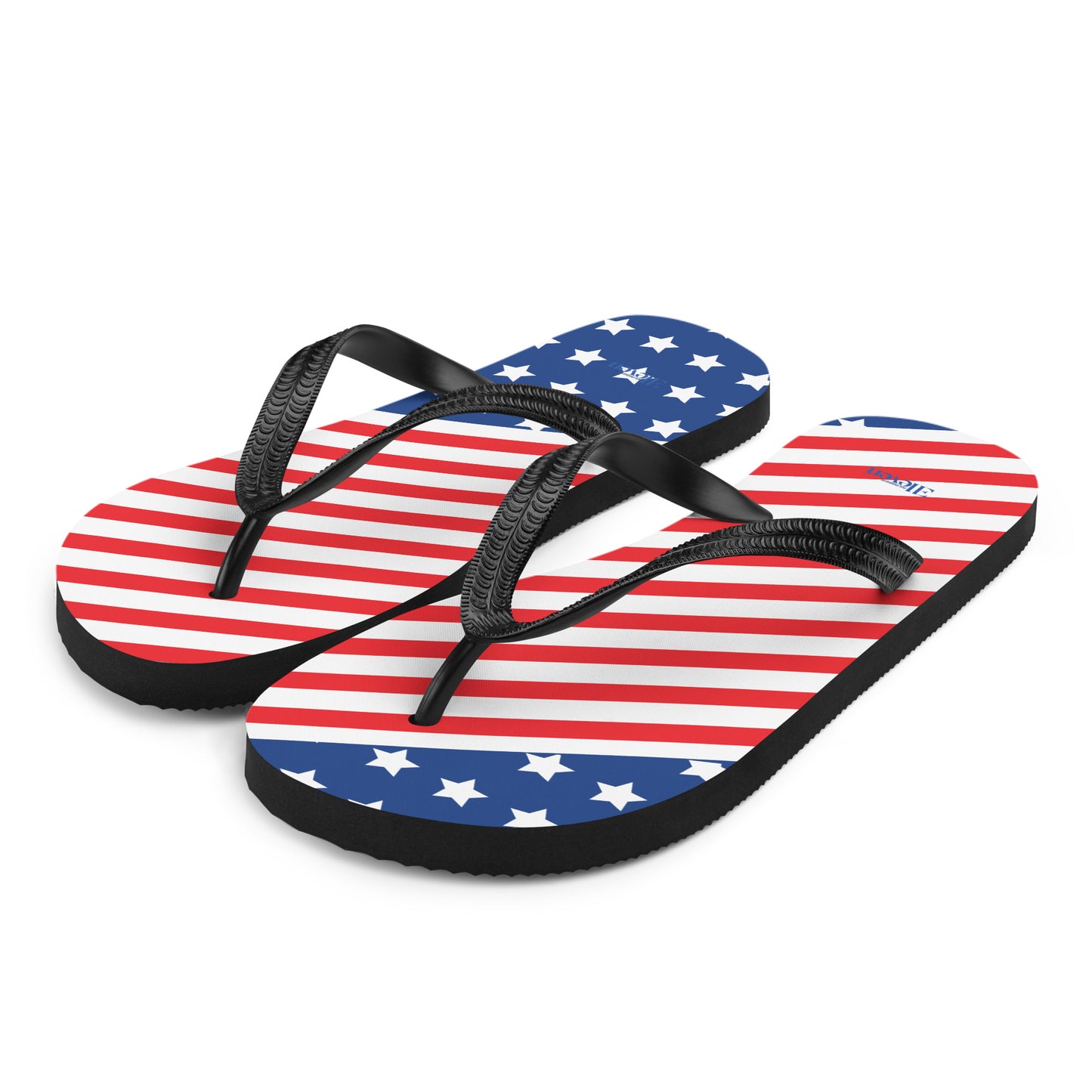 Angled side view of American flag inspired flip flops with stars stripes and black soles