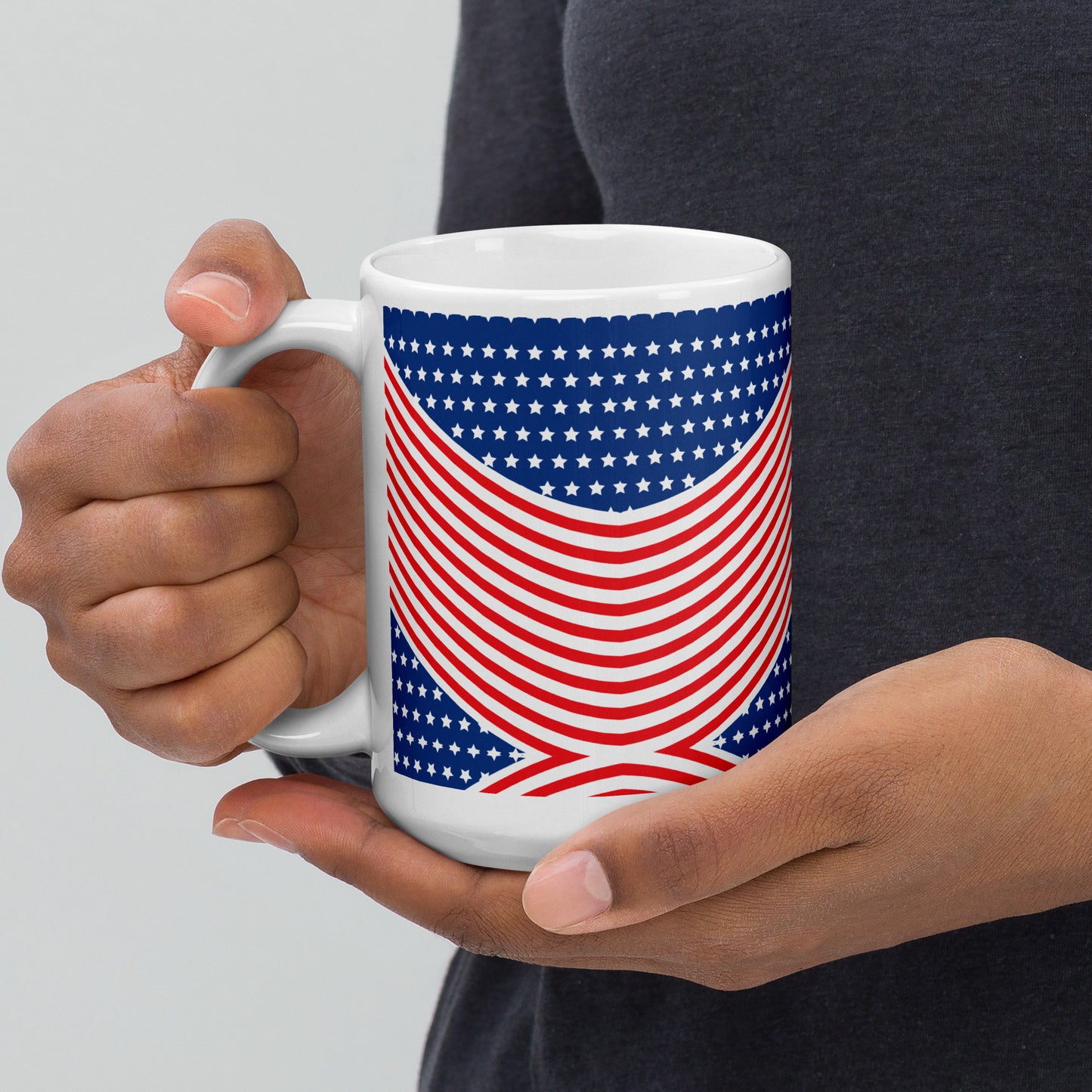 Person holding an American stars and stripes glossy mug with red white blue patriotic wraparound design