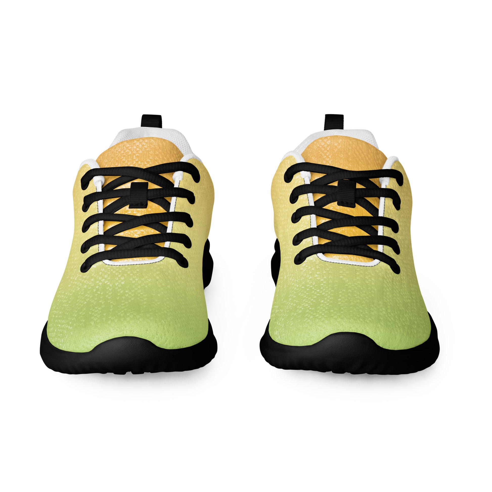 Front view of women’s athletic shoes with light green toe, pale yellow tongue, black laces, and black sole