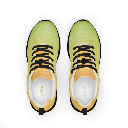 Top view of women’s athletic shoes with pale yellow and green gradient upper, black laces, and black sole