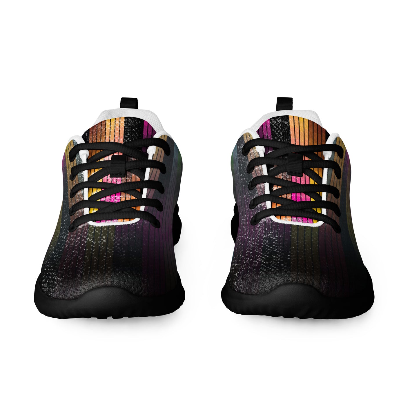 Front view of women’s athletic shoes with dark vertical line pattern, black laces, black sole, and muted multicolor accents