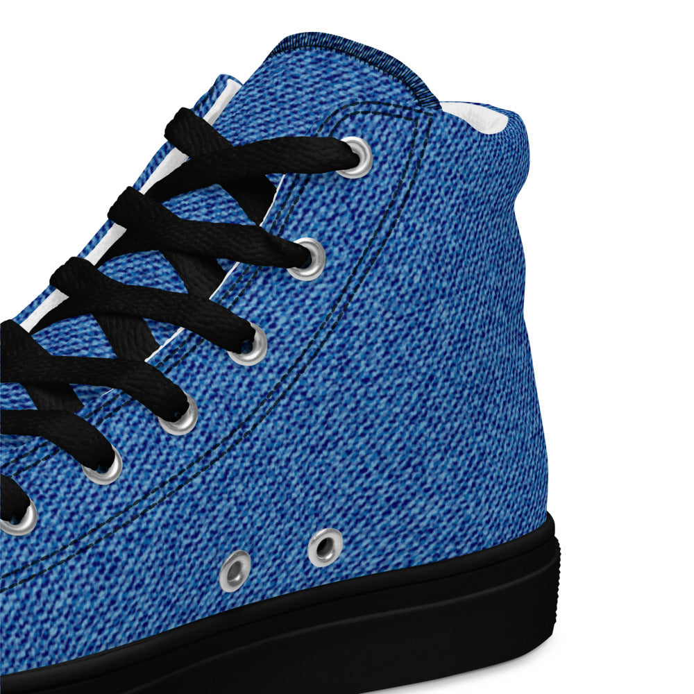 Close-up detail of blue denim texture on women’s high-top sneakers with black laces and black sole