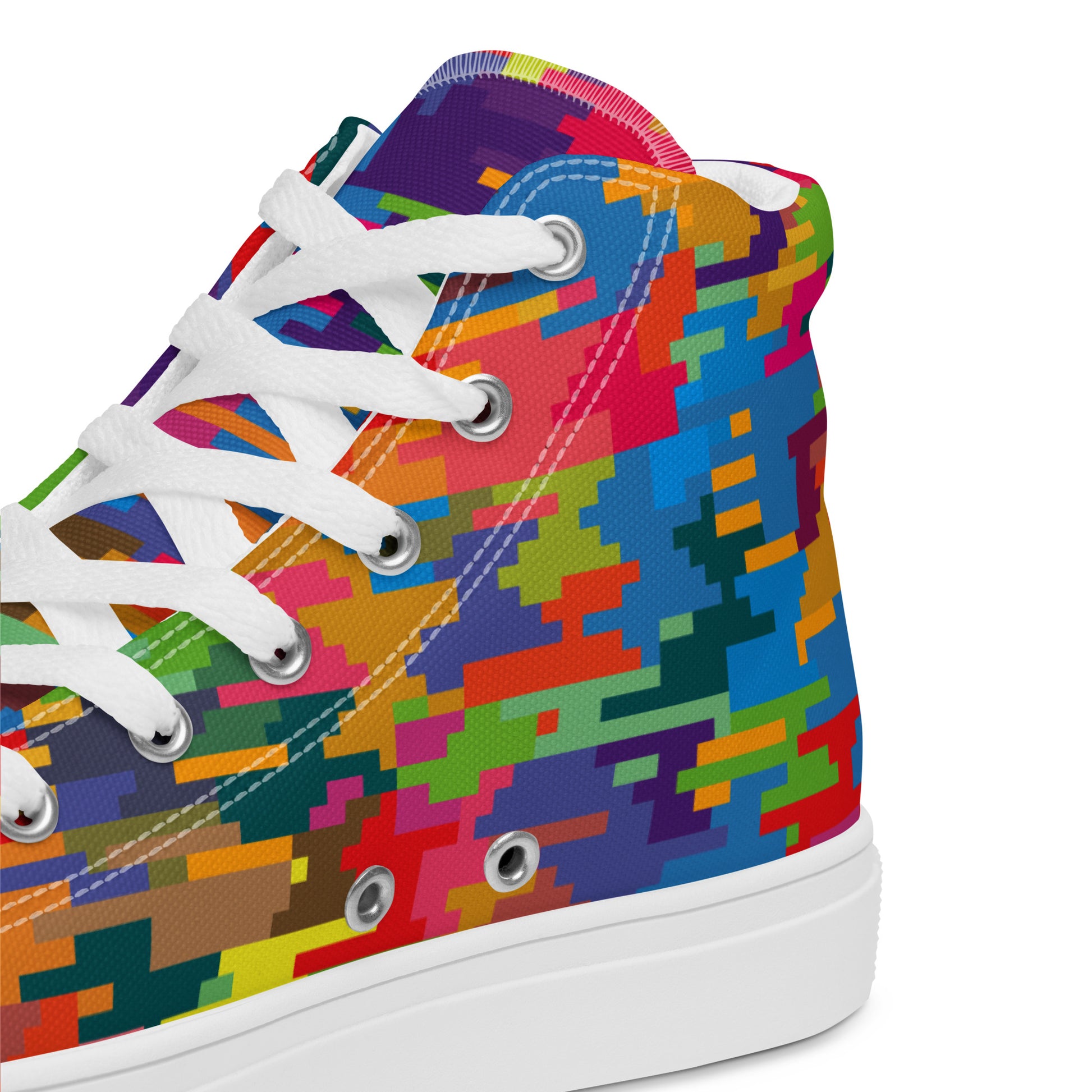 Close-up of women's colorful pixel-pattern high-top sneaker showing canvas texture eyelets and white laces