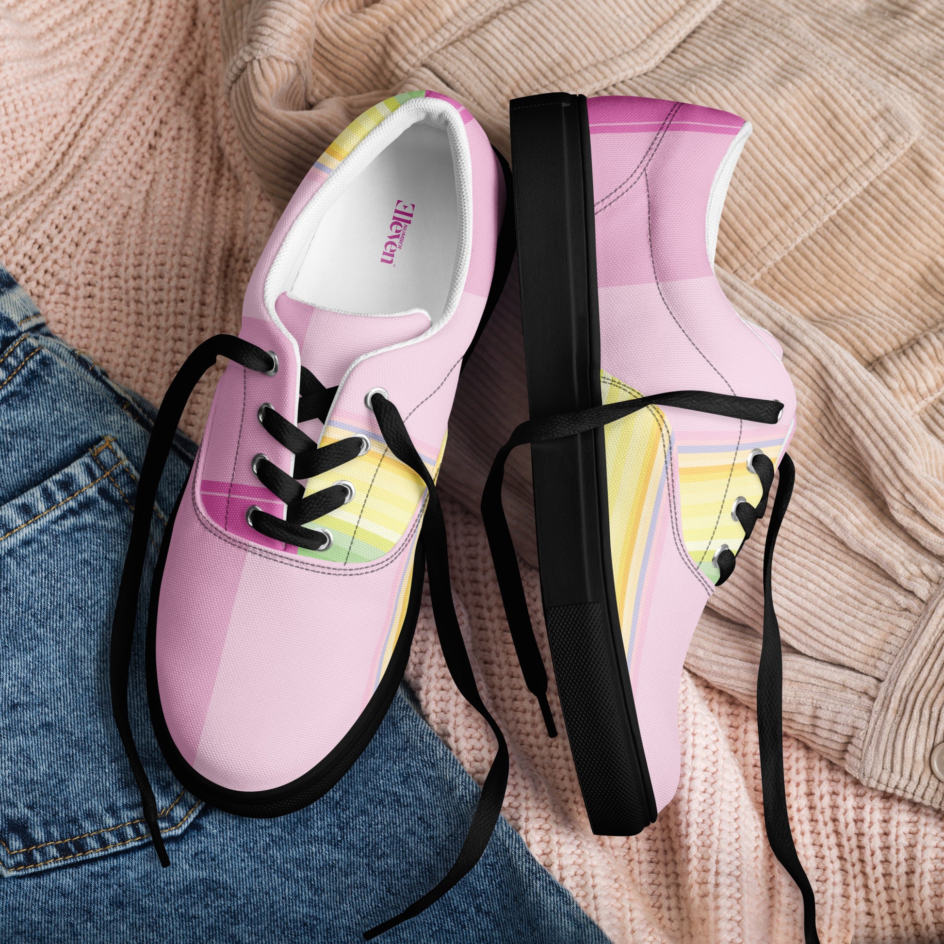 soft pink women’s canvas lace-up shoes with yellow, mint, lavender, and blue stripe design
