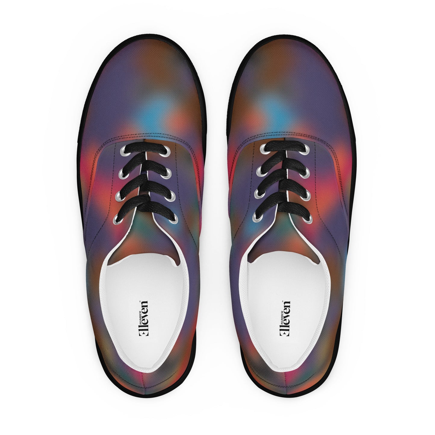 Top view of women’s lace-up canvas shoes with black laces and smoky abstract color blur pattern