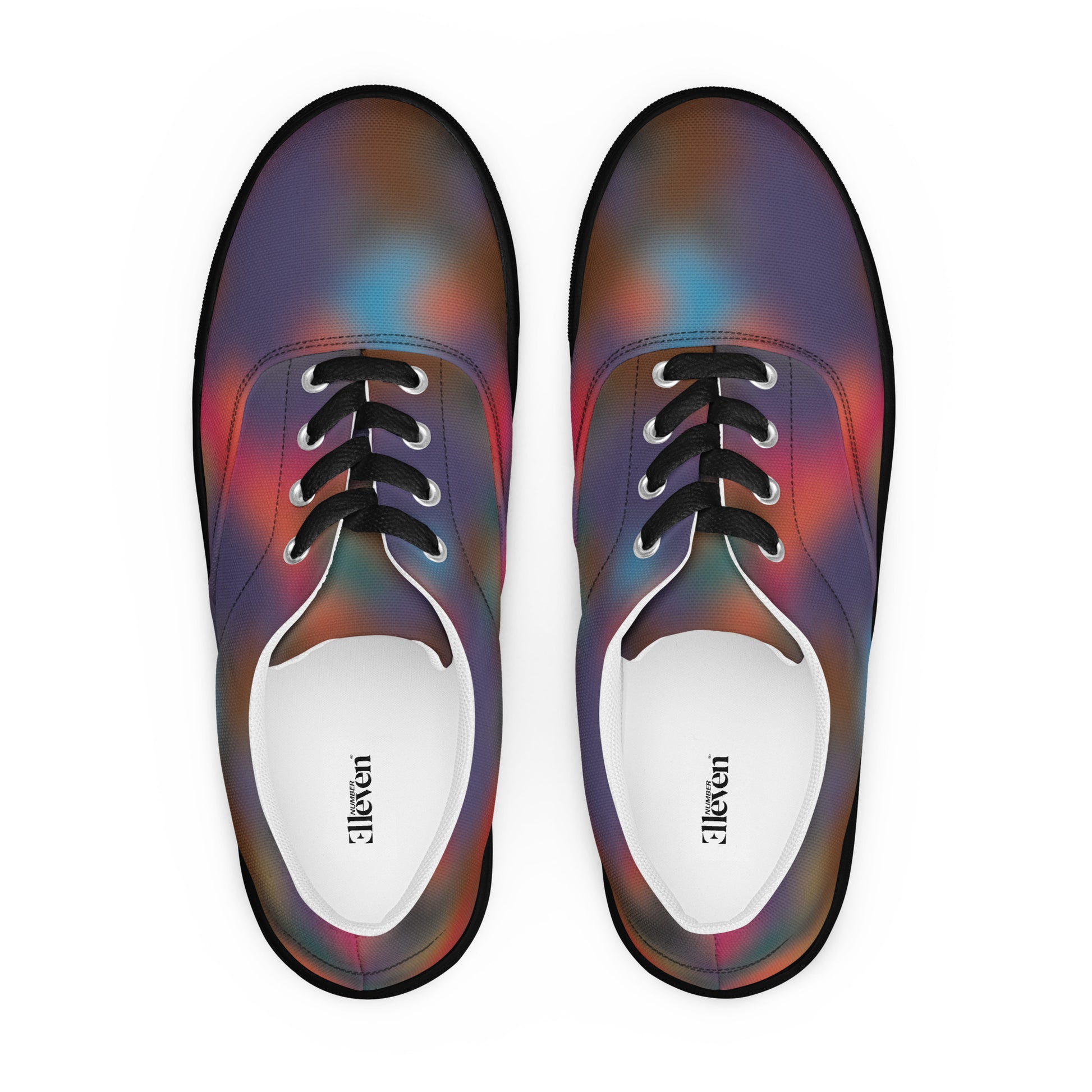 Top view of women’s lace-up canvas shoes with black laces and smoky abstract color blur pattern