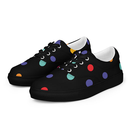 Women’s lace-up canvas shoes with colorful polka dots on black background
