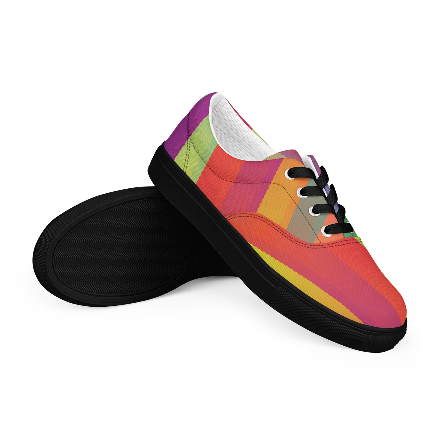 Women’s lace-up canvas shoes with black sole and black laces in a multicolor abstract ribbon stripe design, angled pair view