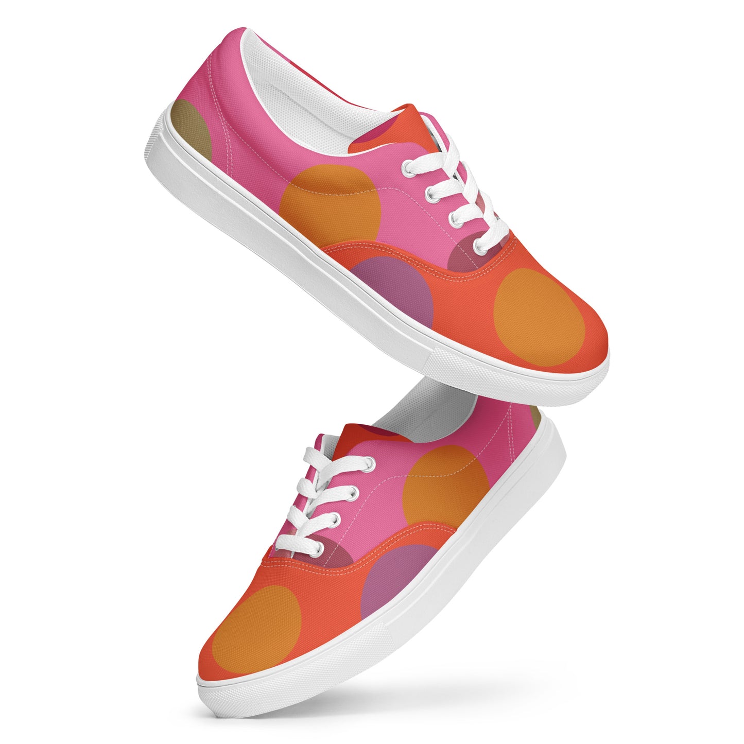pink and coral women’s canvas lace-up shoes with bold circular dot design and playful color blocking