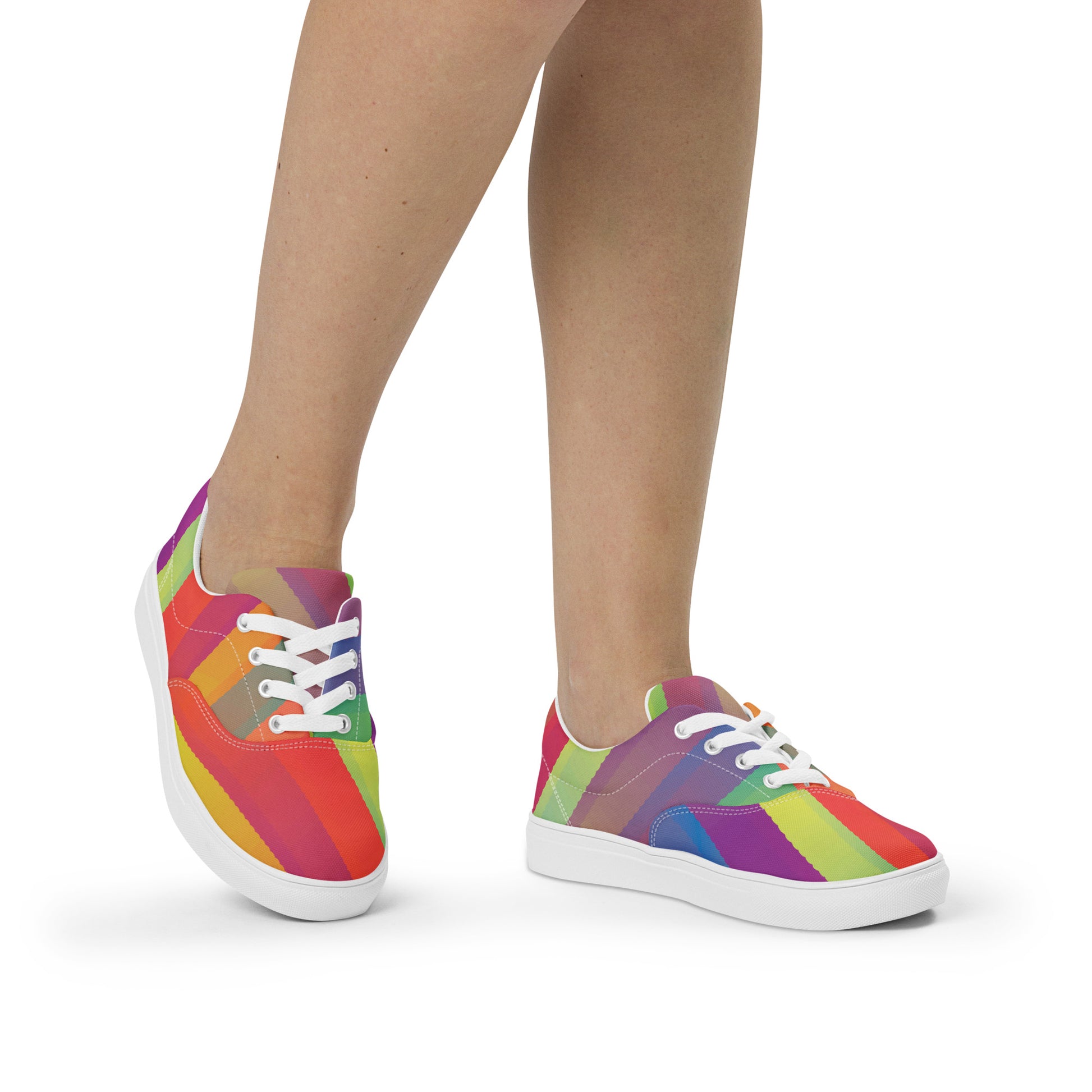 On-foot view of women’s lace-up canvas shoes with white sole and white laces in a vivid multicolor abstract stripe design