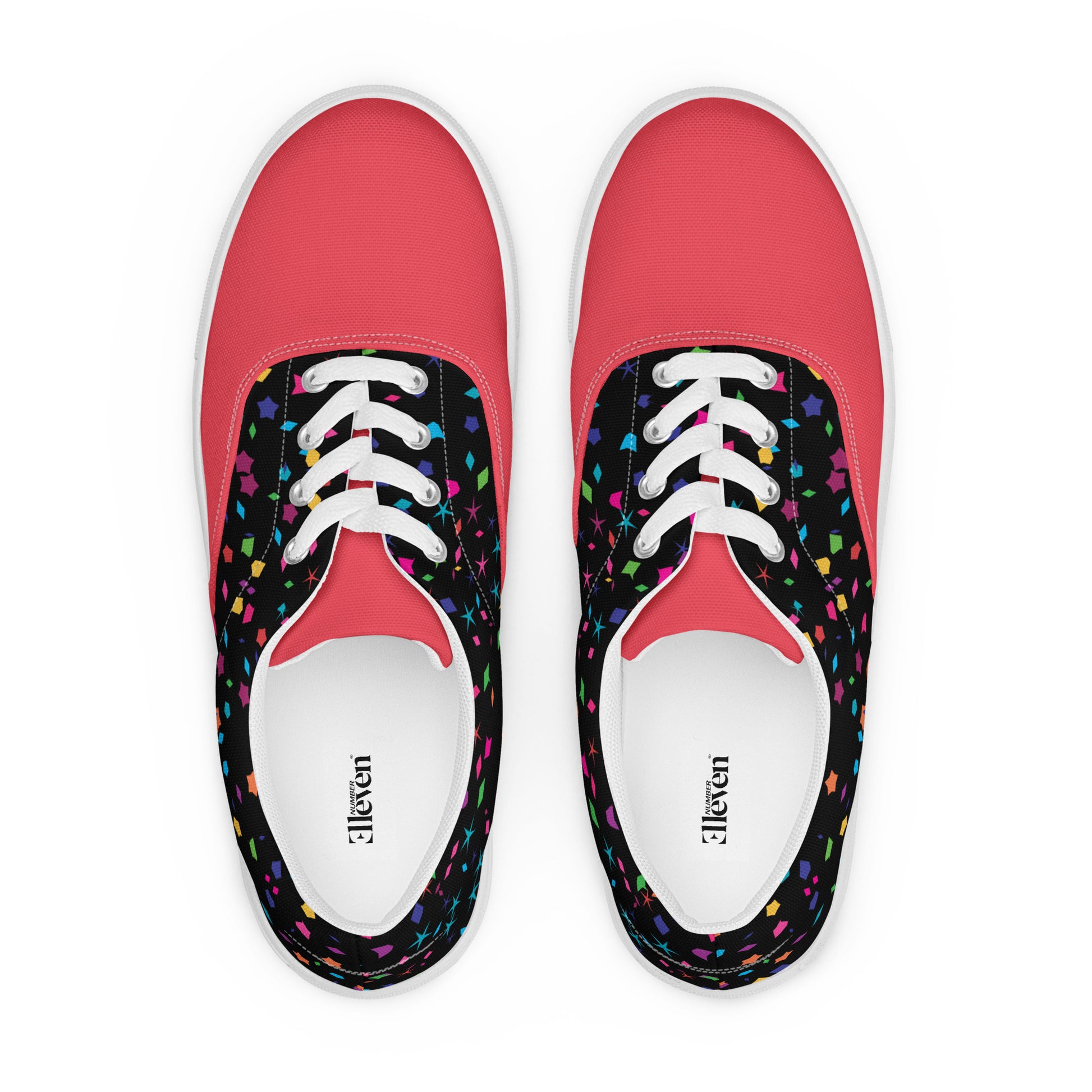 Top view of women’s lace-up canvas shoes with bright coral front panels and multicolor confetti print