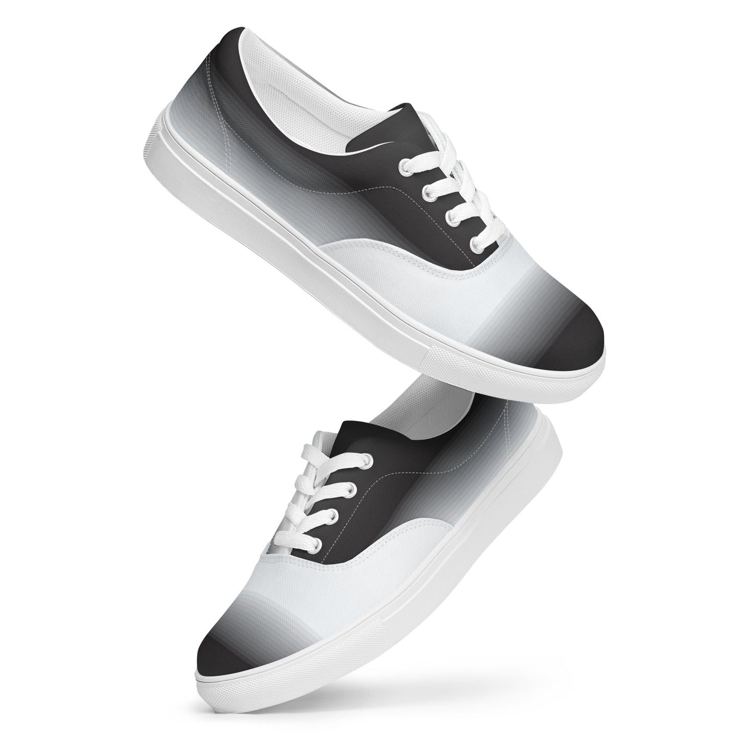 Floating view of women’s lace-up canvas shoes with black to
white gradient pattern and white sole
